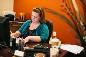 Amy McBride scheduling manager working at her desk