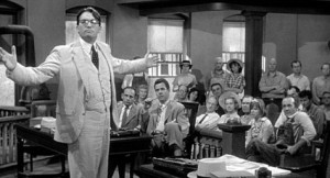 old black and white photo of a man standing in a courtroom