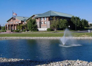 Clarksville building photo from across a lake with a fountain in the middle