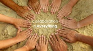 several hands in a circle in the sand with the text "collaboration is everything" in the middle