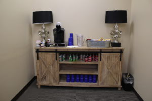 conference room table stocked with drinks and snacks