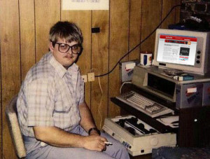 old picture of a man working at an old computer