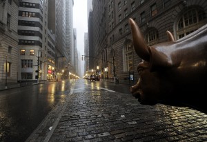 bull statue between two downtown streets